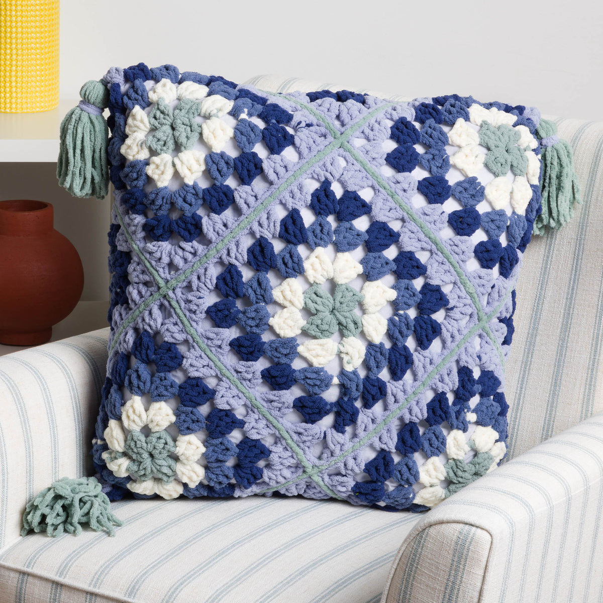 Granny’s diamonds crochet pillow made using Bernat All in One Blanket Granny yarns.